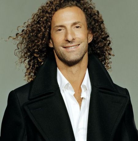 Kenny G in a black jacket poses for a picture.